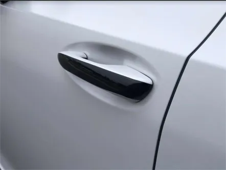White car door handle with a black chrome delete finish completed by Atlantic Custom Wraps in NC