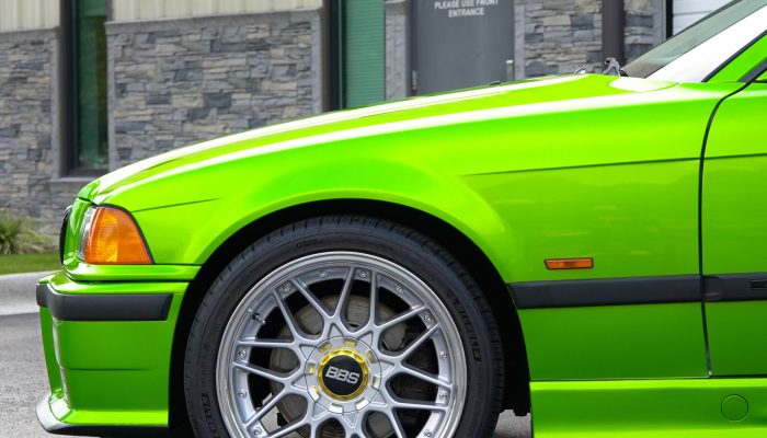 Color-change wrap in bright green on a coupe with silver BBS wheels by Atlantic Custom Wraps in NC