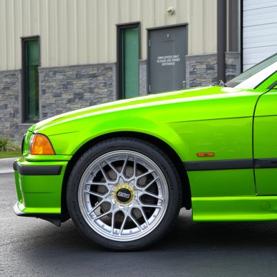 Color-change wrap in bright green on a coupe with silver BBS wheels by Atlantic Custom Wraps in NC
